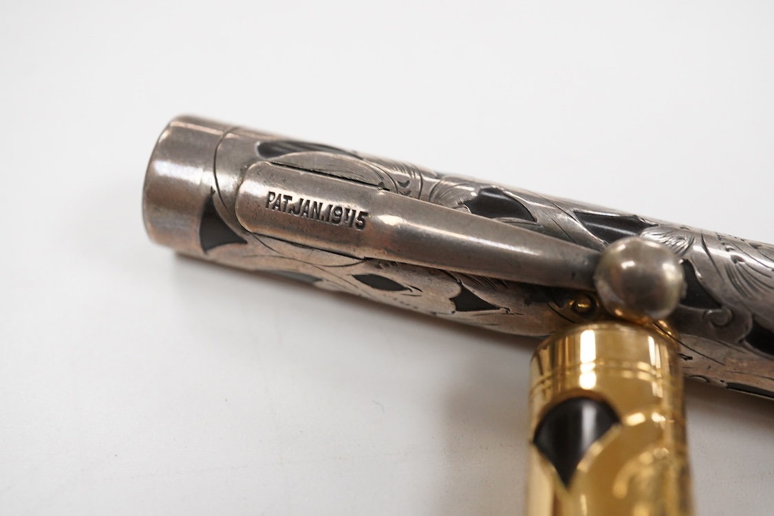 A Swan MT & Co. sterling silver filigree eyedropper along with similar gold filled example
